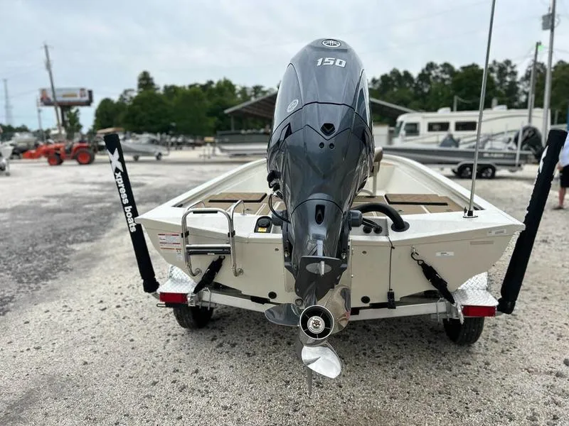 Slide: The Image of 2025 Xpress H210B boat with powerful outboard motor, parked on a trailer. - 4