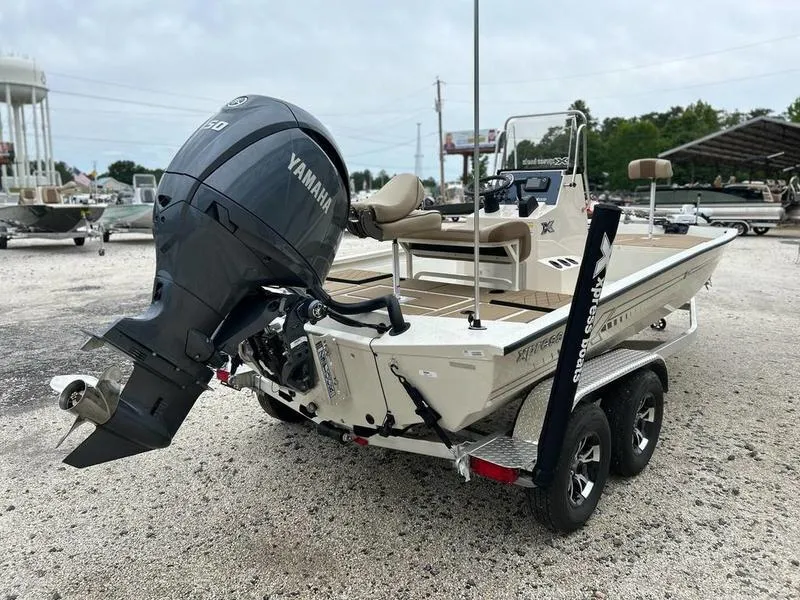 Slide: The Image of 2025 Xpress H210B boat with Yamaha engine on trailer in outdoor setting. - 5