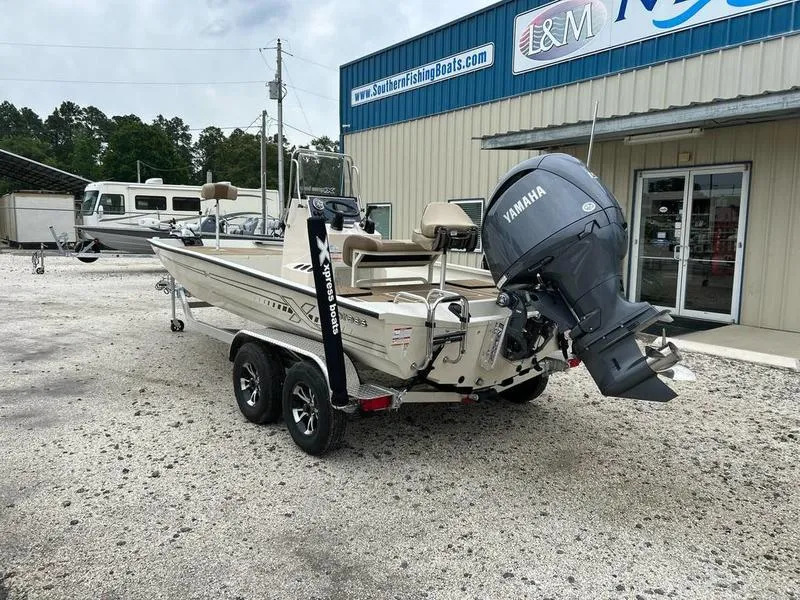 Slide: The Image of 2025 Xpress H210B boat with Yamaha motor on trailer outside dealership. - 6