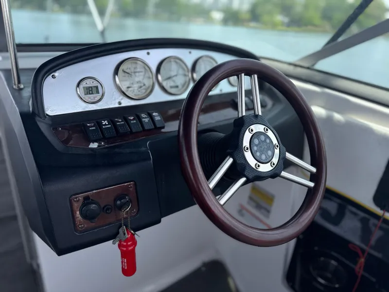 Slide: The Image of 2008 Regal 2520 FasDeck boat dashboard with steering wheel and gauges. - 10
