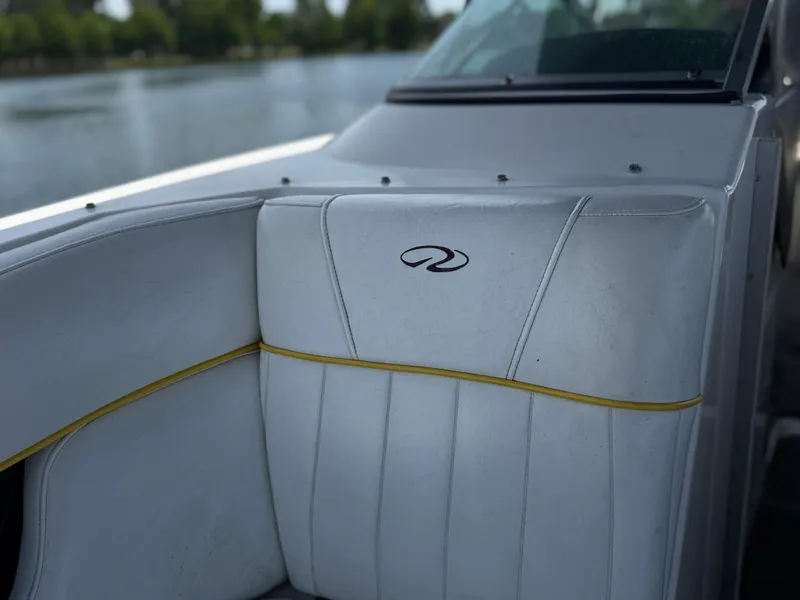 Slide: The Image of 2008 Regal 2520 FasDeck boat interior with white seating and logo detail. - 12