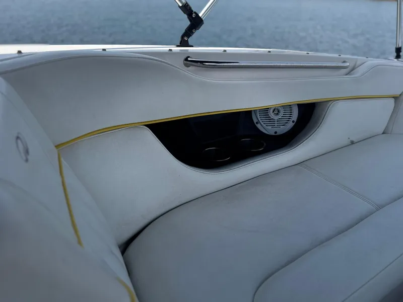 Slide: The Image of Interior of 2008 Regal 2520 FasDeck boat with white seating and speaker detail. - 14