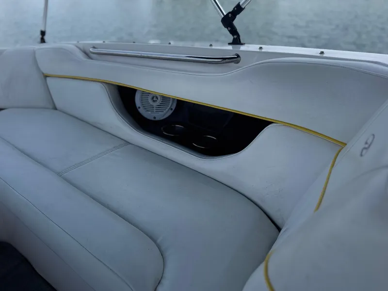 Slide: The Image of 2008 Regal 2520 FasDeck boat interior with white seating and speaker detail. - 15