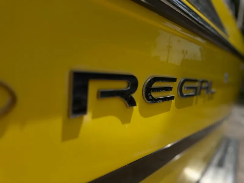 Slide: The Image of Close-up of 2008 Regal 2520 FasDeck logo on a yellow surface. - 3