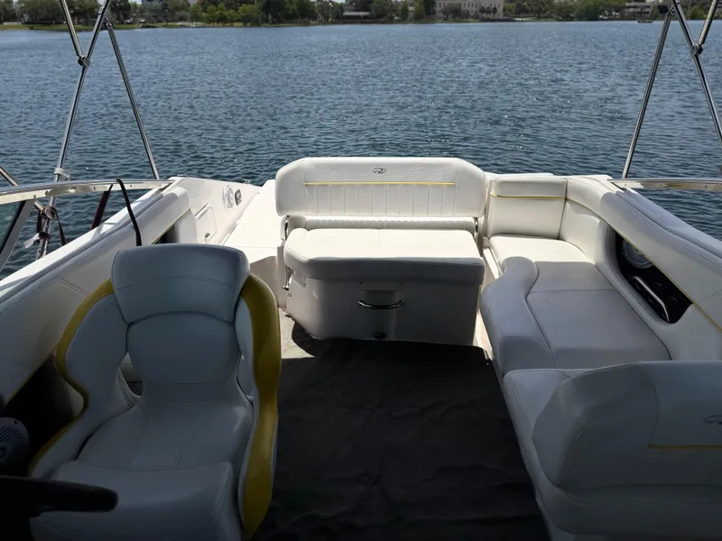 Slide: The Image of 2008 Regal 2520 FasDeck boat interior with white seating, overlooking calm water. - 7