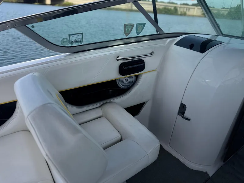 Slide: The Image of Interior of 2008 Regal 2520 FasDeck boat with white seating and water view. - 9