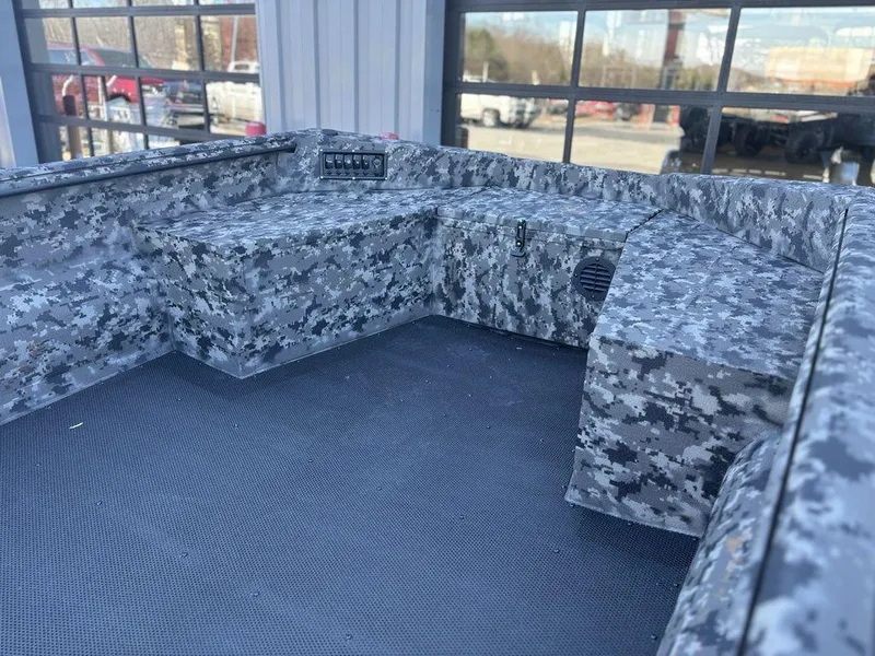 Slide: The Image of 2025 Havoc 1656 VJST boat interior with camo design and control panel. - 12