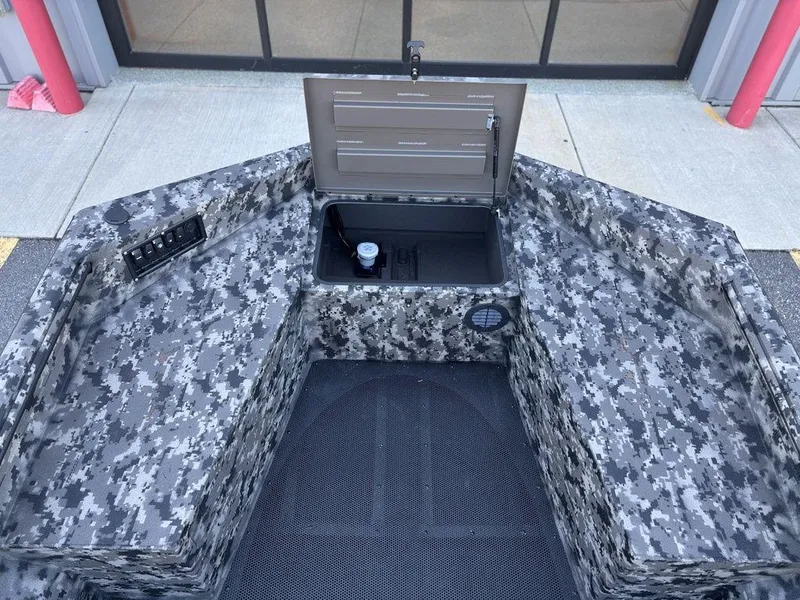 Slide: The Image of 2025 Havoc 1656 VJST boat interior with camo design and open storage compartment. - 14