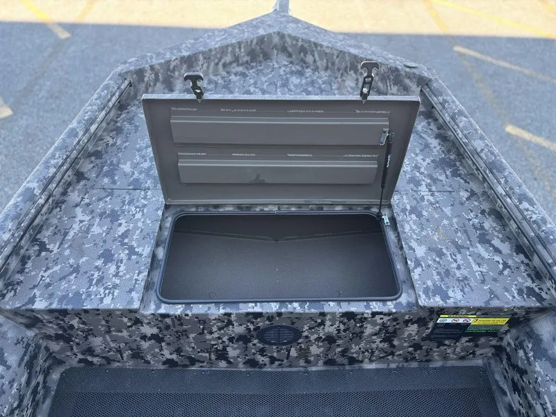 Slide: The Image of Open storage compartment on 2025 Havoc 1656 VJST boat with camo pattern. - 15