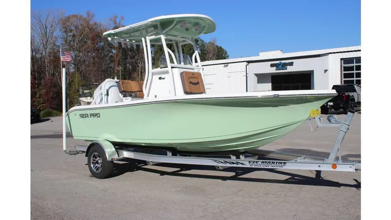 Slide: The Image of 2025 Sea Pro 202 CC boat on trailer, light green hull, parked outdoors. - 4