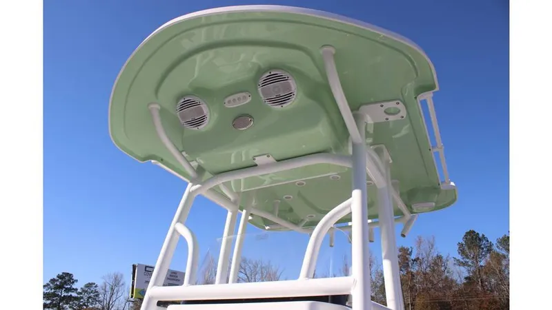 Slide: The Image of 2025 Sea Pro 202 CC boat T-top with speakers against clear blue sky. - 5