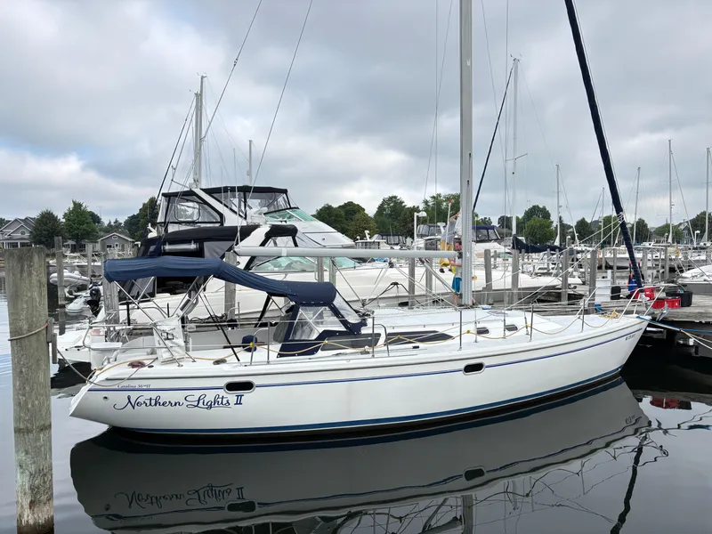 The Image of 2002 Catalina 36MKII sailboat docked at marina, overcast sky, calm water. - 0