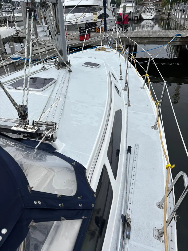 Slide: The Image of 2002 Catalina 36MKII sailboat docked, showcasing deck and rigging details. - 13