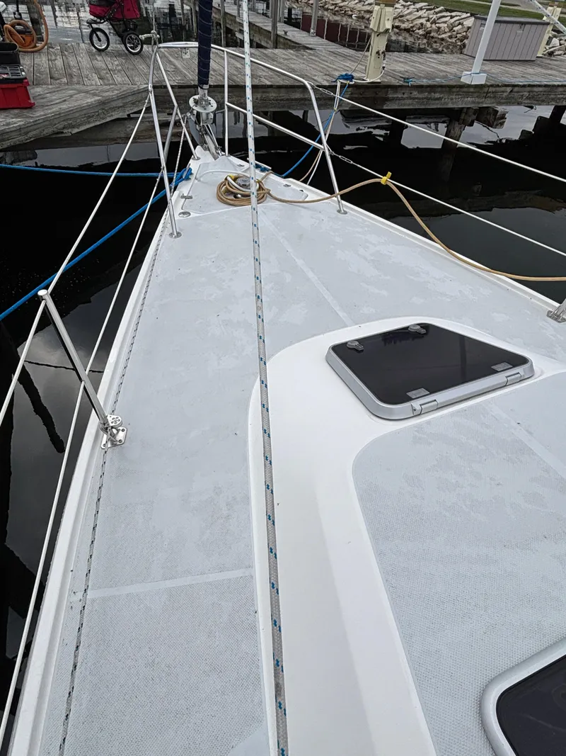 Slide: The Image of Deck view of a 2002 Catalina 36MKII sailboat docked at a marina. - 19