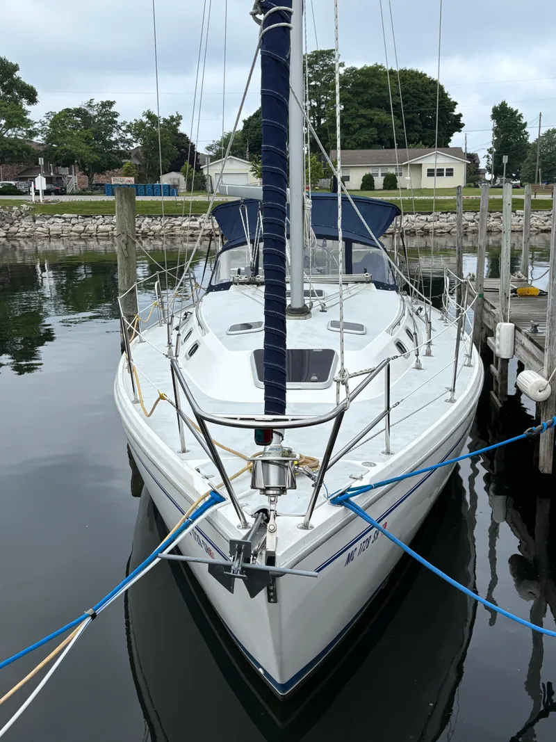 Slide: The Image of 2002 Catalina 36MKII sailboat docked in a calm marina setting. - 3