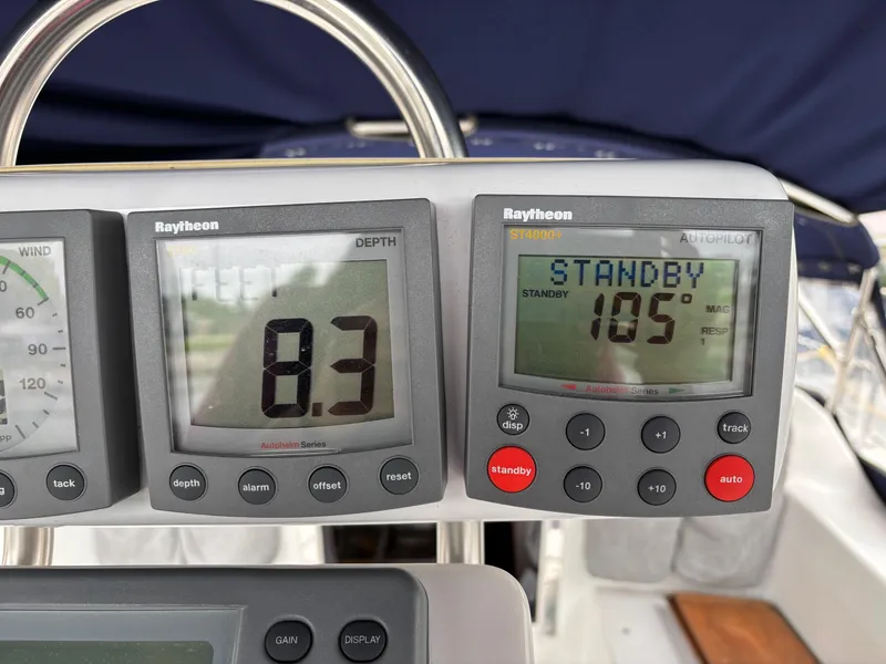 Slide: The Image of Raytheon depth and autopilot displays on 2002 Catalina 36MKII sailboat dashboard. - 31