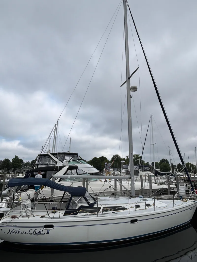 Slide: The Image of 2002 Catalina 36MKII sailboat docked at marina under cloudy sky. - 4