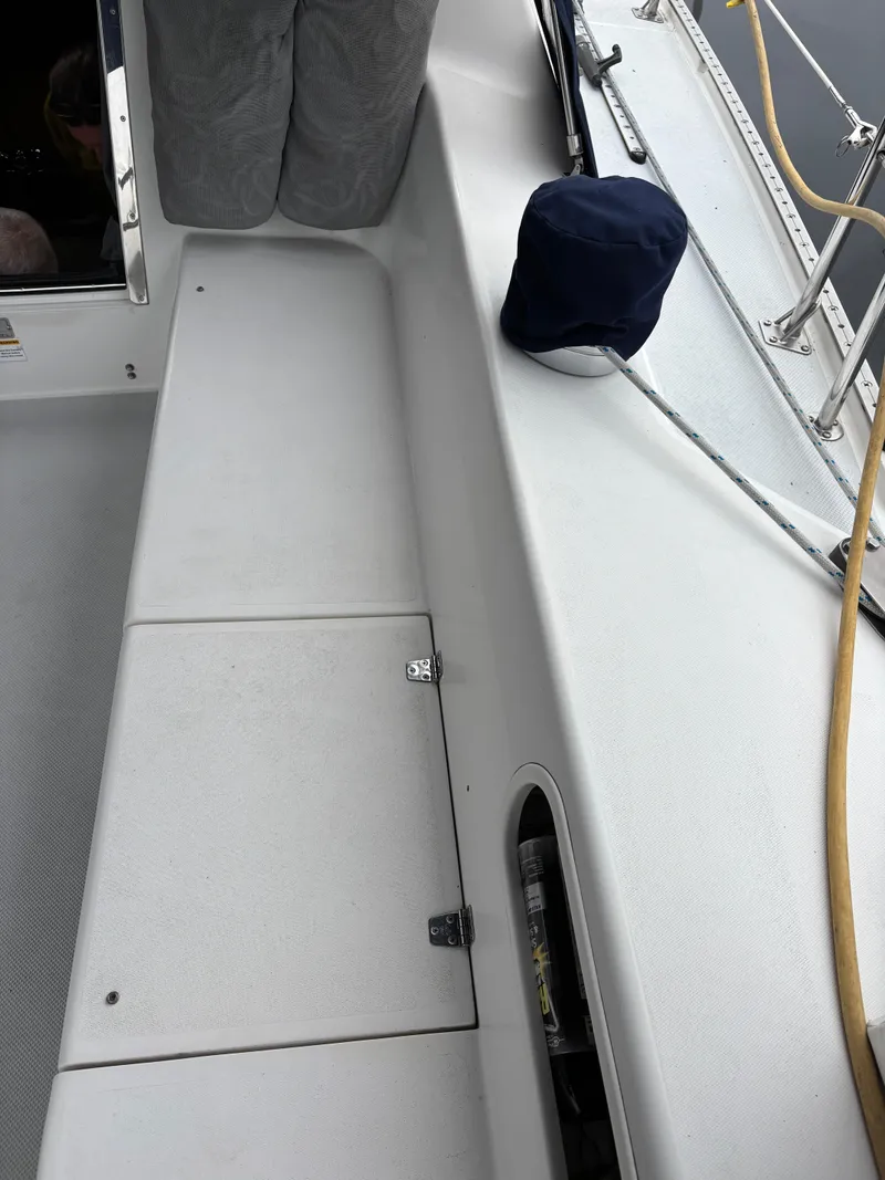 Slide: The Image of 2002 Catalina 36MKII sailboat deck with storage compartment and navy cap. - 41