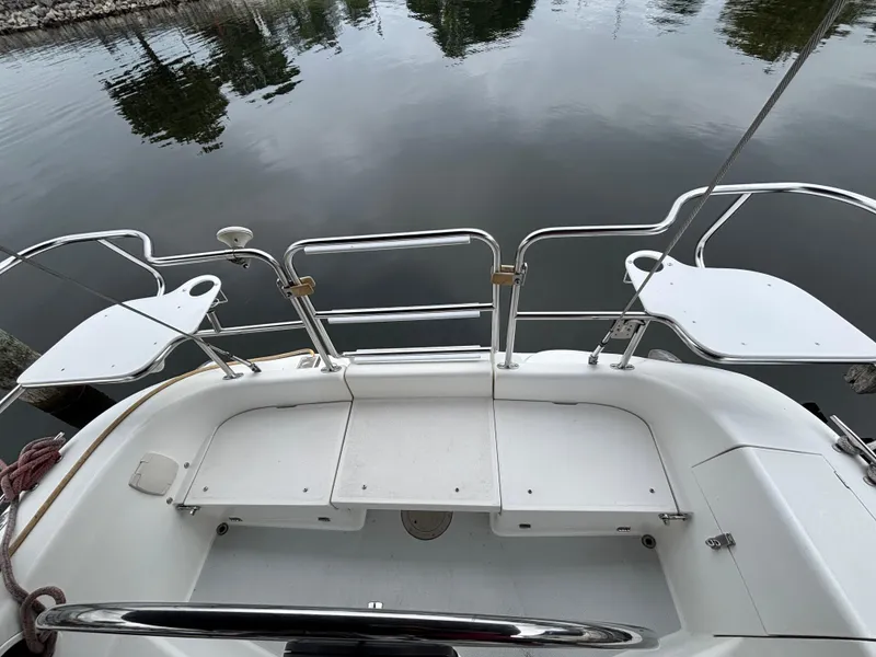 Slide: The Image of Cockpit view of a 2002 Catalina 36MKII sailboat, docked by calm waters. - 44
