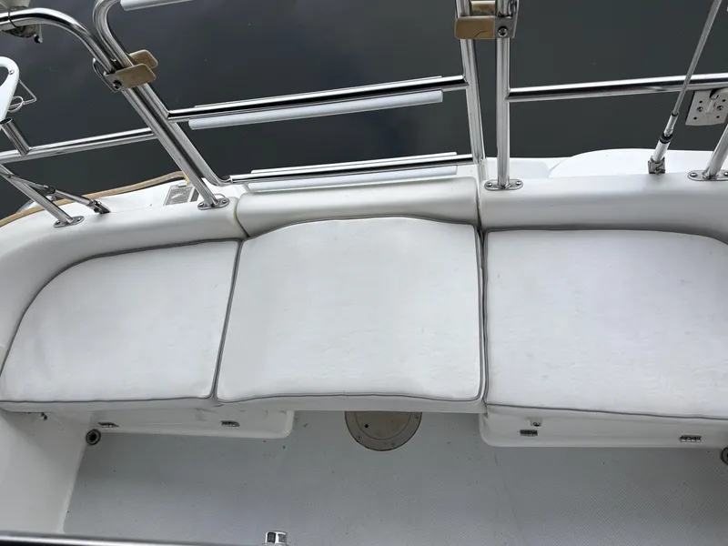 Slide: The Image of White cushioned seating on a 2002 Catalina 36MKII sailboat deck. - 45