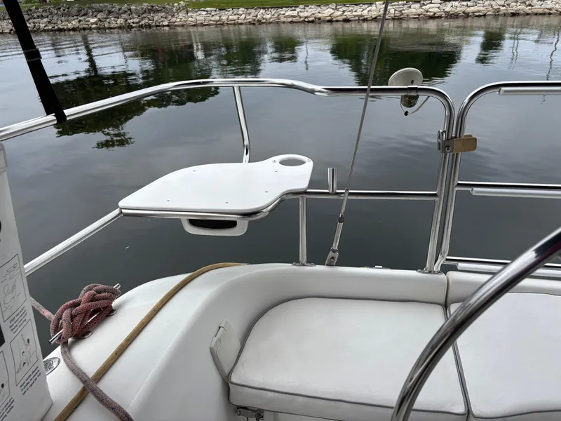 Slide: The Image of Catalina 36MKII sailboat cockpit with seating and railing, docked by calm water. - 47