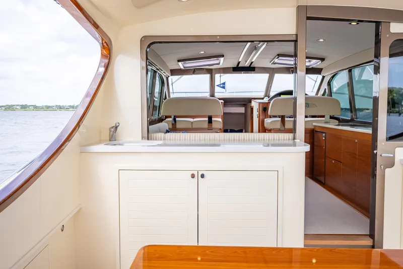 Slide: The Image of Interior of 2018 Palm Beach Motor Yachts PB45, featuring elegant wood and modern design. - 17