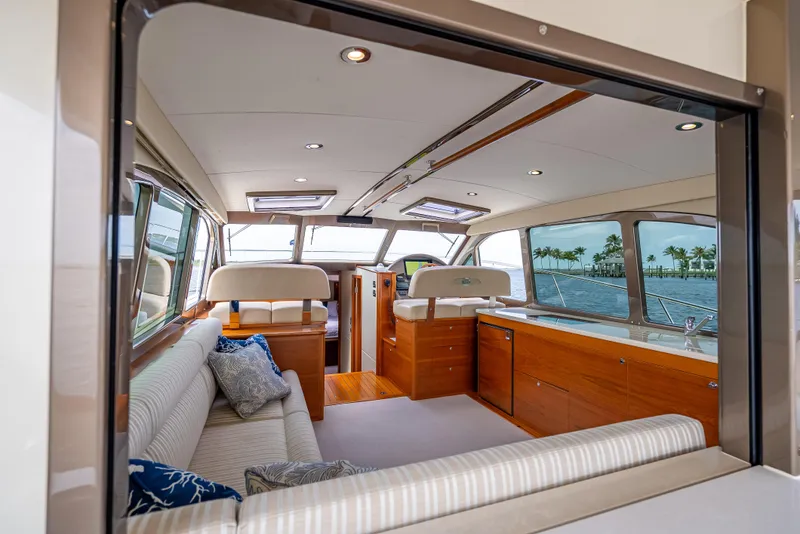 Slide: The Image of Luxurious interior of 2018 Palm Beach Motor Yachts PB45 with elegant seating and panoramic windows. - 18
