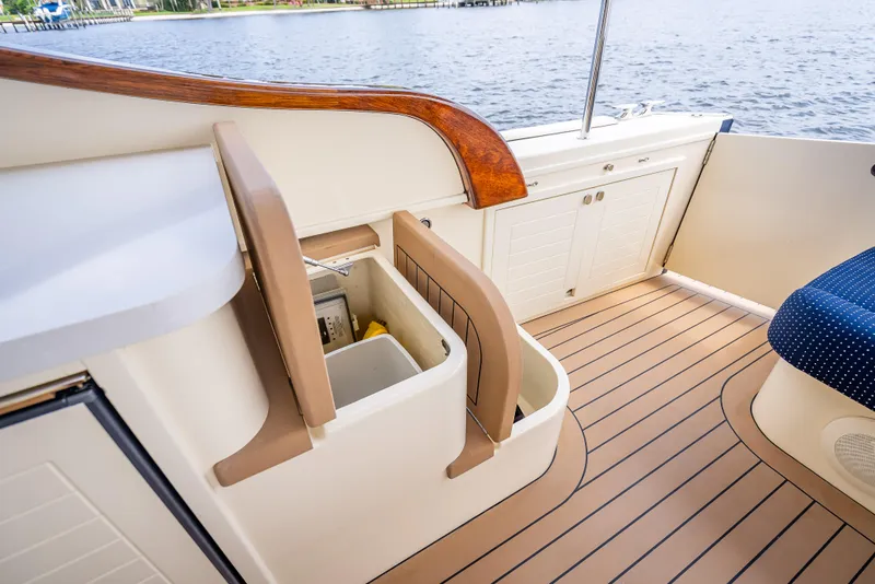 Slide: The Image of 2018 Palm Beach Motor Yachts PB45 interior with storage compartment and elegant wood finish. - 20