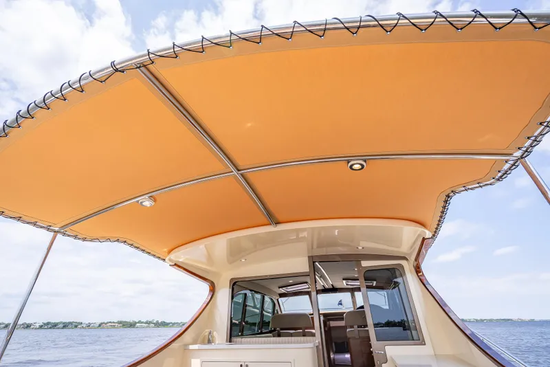Slide: The Image of 2018 Palm Beach Motor Yachts PB45 with orange canopy, cruising on a sunny day. - 22