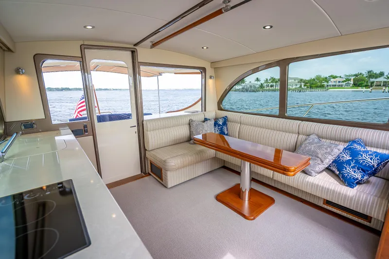 Slide: The Image of Luxurious 2018 Palm Beach Motor Yachts PB45 interior with elegant seating and scenic water views. - 28