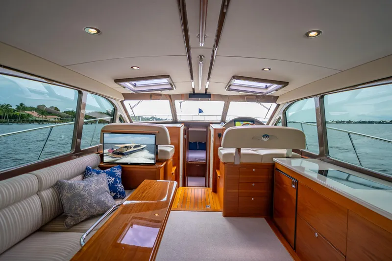 Slide: The Image of Luxurious interior of 2018 Palm Beach Motor Yachts PB45, featuring elegant wood finishes and panoramic windows. - 31