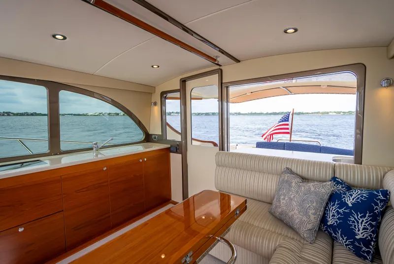 Slide: The Image of Interior of 2018 Palm Beach Motor Yachts PB45 with elegant seating and water view. - 32
