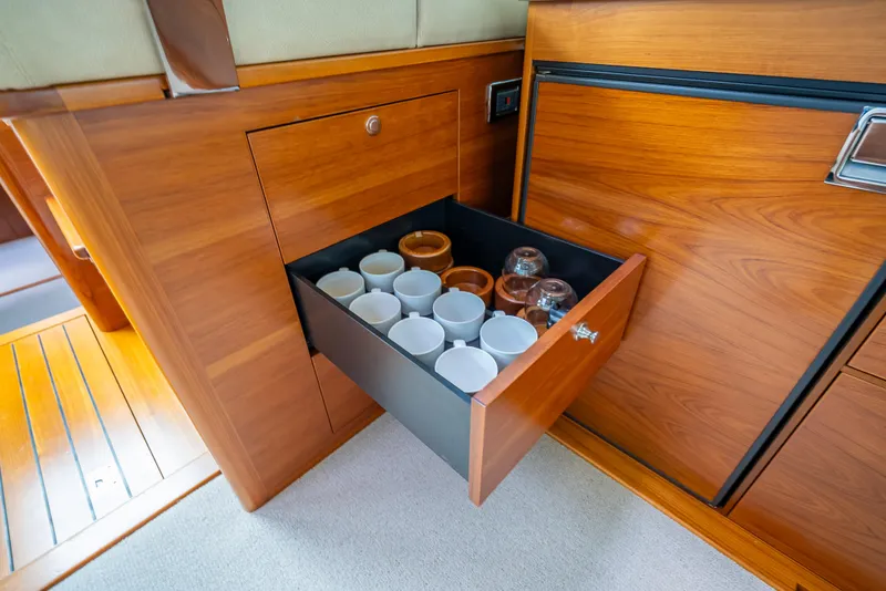 Slide: The Image of Open drawer with cups and jars in 2018 Palm Beach Motor Yachts PB45 interior. - 37