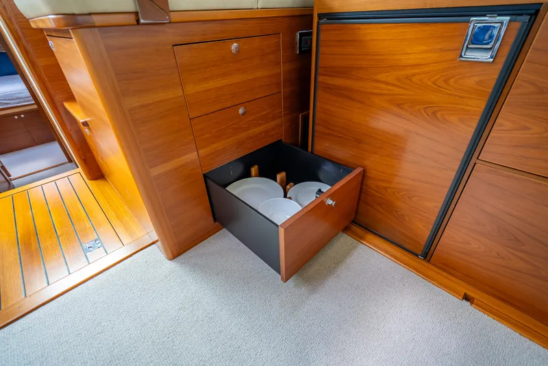 Slide: The Image of Wooden interior of 2018 Palm Beach Motor Yachts PB45 with open drawer showing plates. - 38