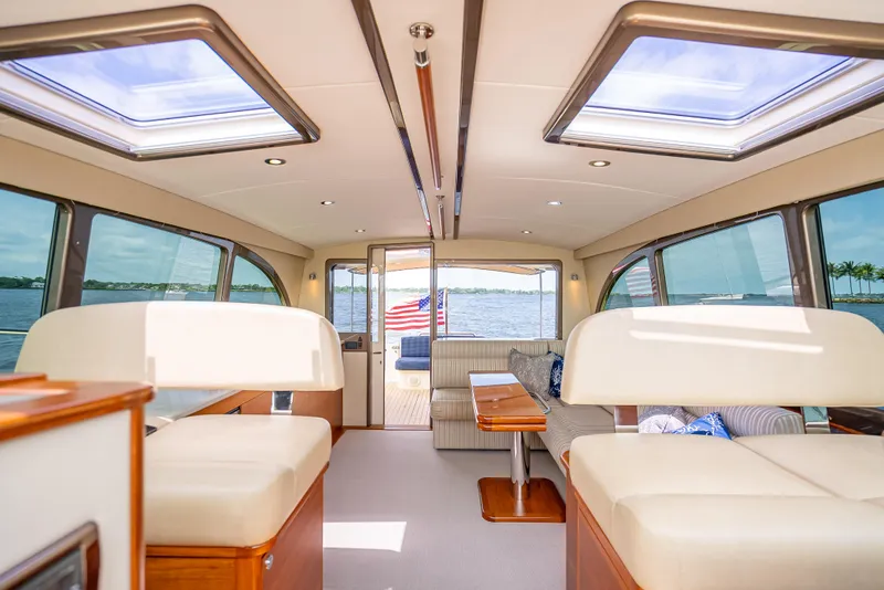 Slide: The Image of Luxurious interior of 2018 Palm Beach Motor Yachts PB45 with panoramic windows and elegant seating. - 40