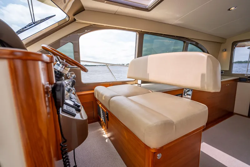 Slide: The Image of 2018 Palm Beach Motor Yachts PB45 interior with luxurious seating and helm view. - 43