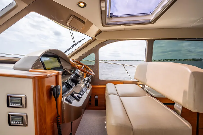Slide: The Image of Interior of 2018 Palm Beach Motor Yachts PB45, featuring luxurious helm and seating. - 44