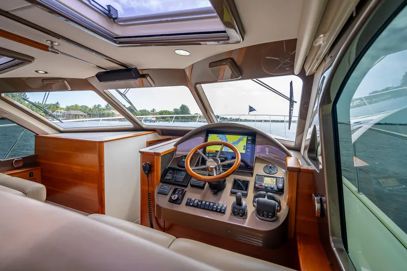 Slide: The Image of 2018 Palm Beach Motor Yachts PB45 helm with modern controls and panoramic view. - 48