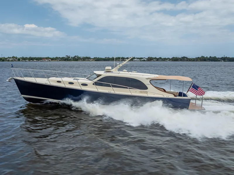 Slide: The Image of 2018 Palm Beach Motor Yachts PB45 cruising on open water, displaying sleek design and elegance. - 5