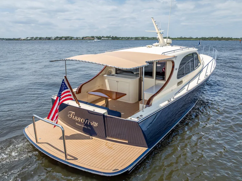 Slide: The Image of 2018 Palm Beach Motor Yachts PB45 cruising on open water, featuring elegant design and American flag. - 8