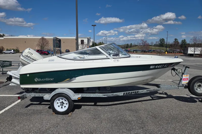 Slide: The Image of Silverline 1600 boat on trailer, 2003 model, parked outdoors under a clear blue sky. - 1