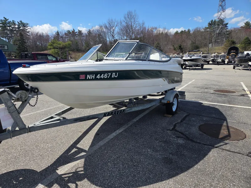 Slide: The Image of 2003 Silverline 1600 boat on trailer in parking lot, clear sky background. - 2