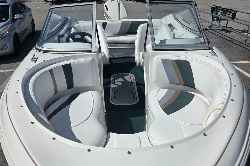 Slide: The Image of 2003 Silverline 1600 boat interior with white seating and green accents. - 4