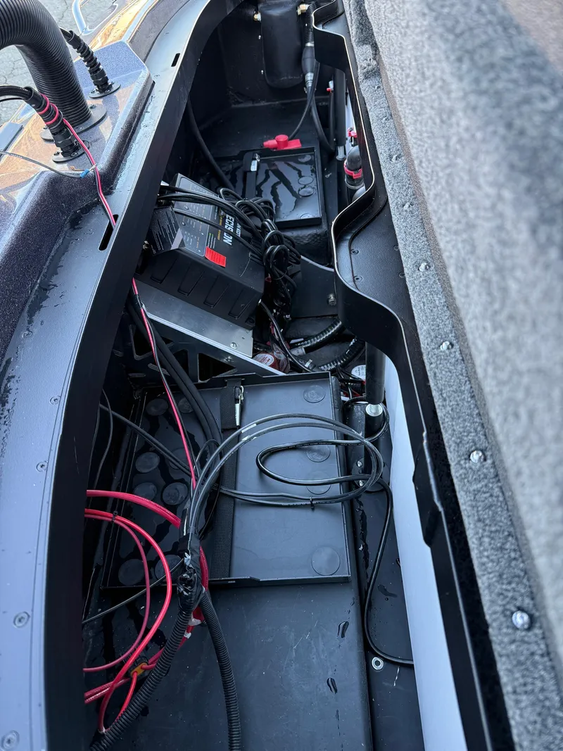Slide: The Image of Interior view of 2025 Skeeter ZXR 20 SE boat, showcasing wiring and battery setup. - 11