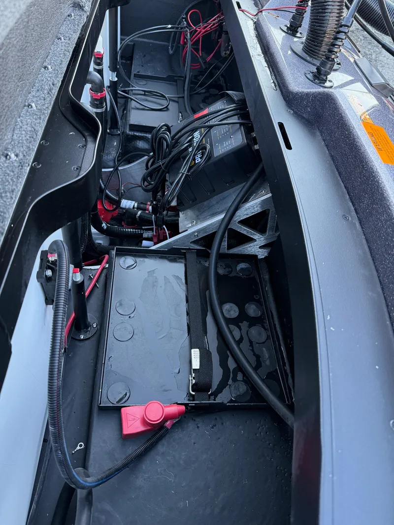 Slide: The Image of Interior view of a 2025 Skeeter ZXR 20 SE boat, showcasing battery and wiring components. - 12