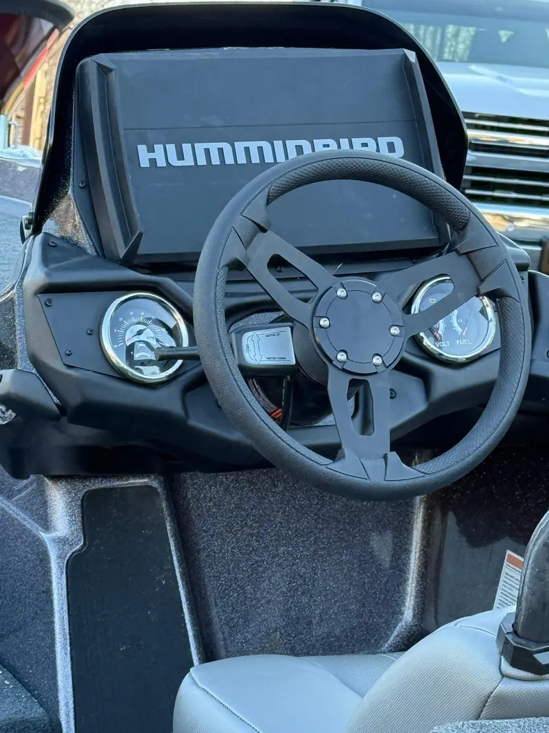 Slide: The Image of 2025 Skeeter ZXR 20 SE boat dashboard with steering wheel and Humminbird display. - 13