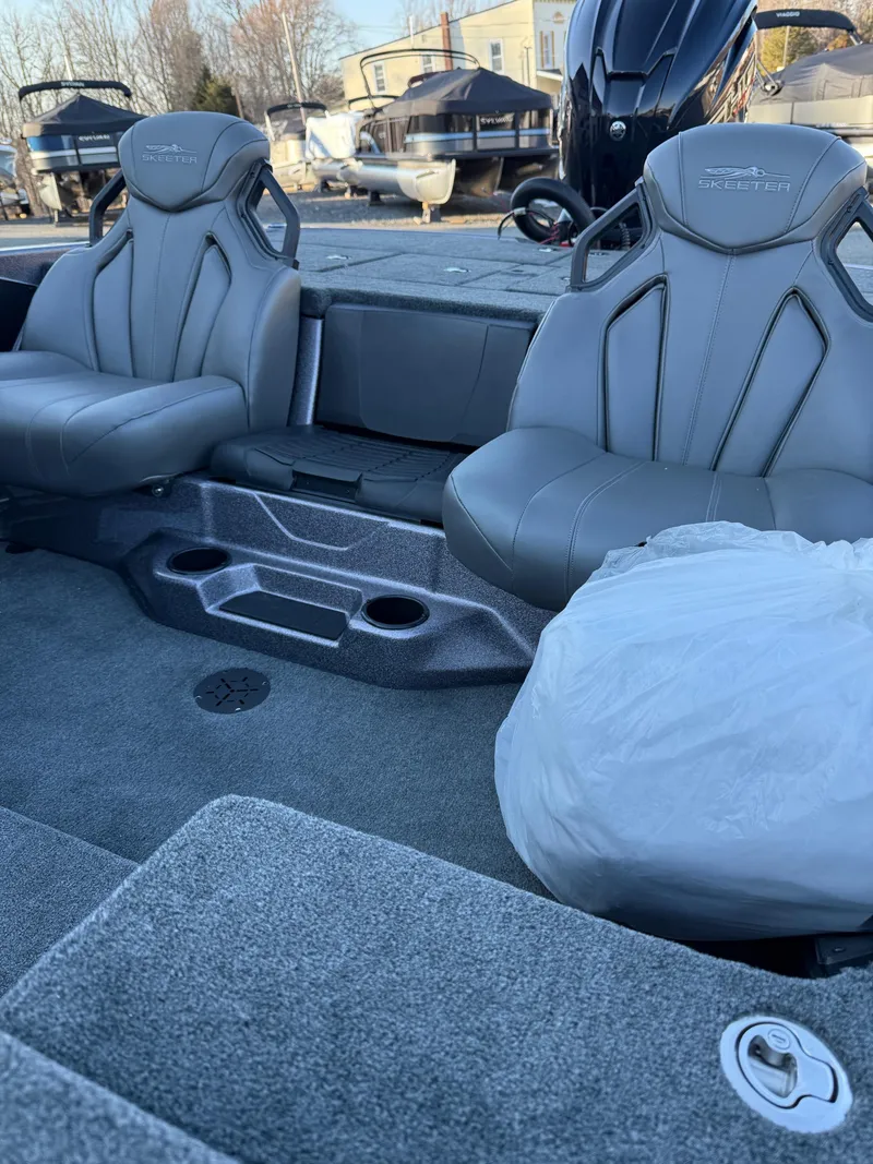 Slide: The Image of 2025 Skeeter ZXR 20 SE boat interior with gray seating and storage compartments. - 16