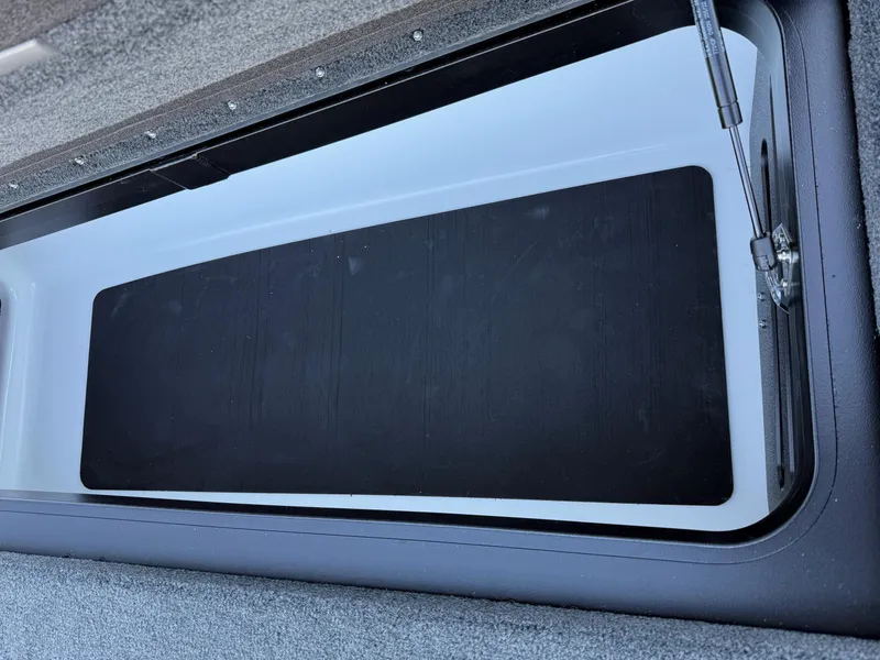 Slide: The Image of 2025 Skeeter ZXR 20 SE boat storage compartment with open lid, showcasing interior design. - 19