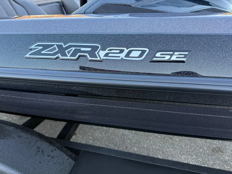 Slide: The Image of 2025 Skeeter ZXR 20 SE boat model emblem on sleek black surface. - 2