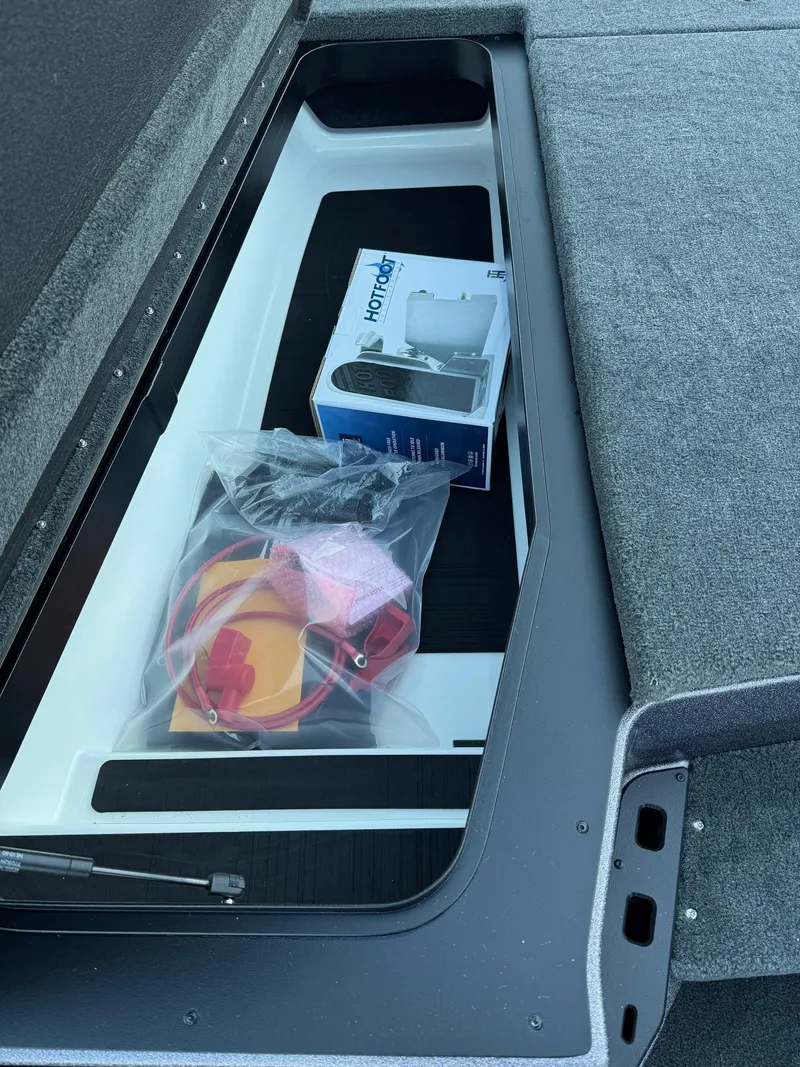 Slide: The Image of 2025 Skeeter ZXR 20 SE storage compartment with accessories and equipment. - 20